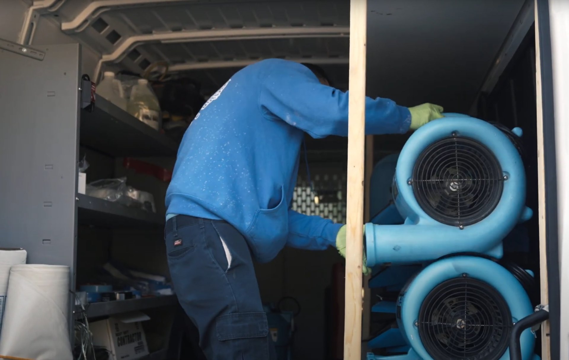 Professional water damage restoration services covered by insurance in Katy, TX Water damage restoration technician in protective gear working in damaged basement